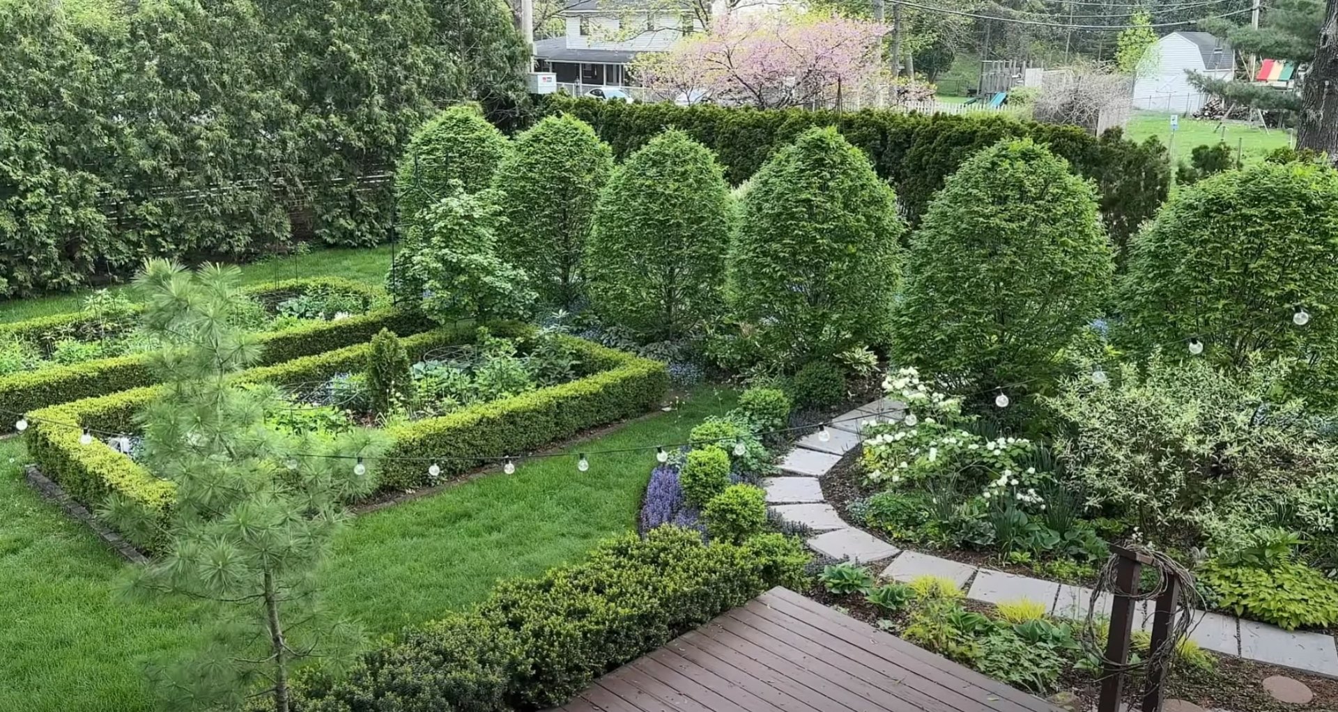 Formal garden design with structured hedges and pathway lighting