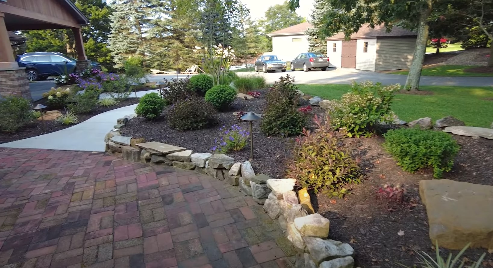 Aerial view of expertly designed landscape with curved pathways and diverse plantings